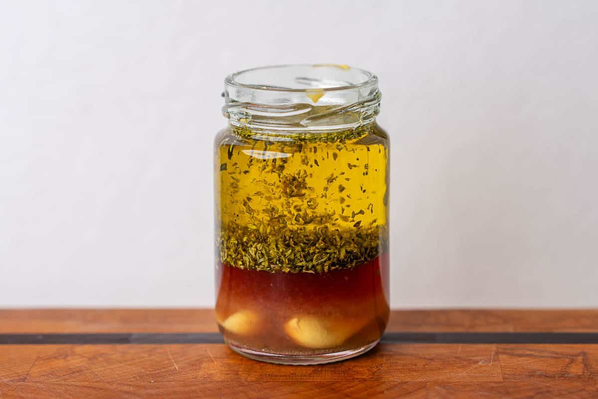Dressing ingredients added to a glass jar before being mixed