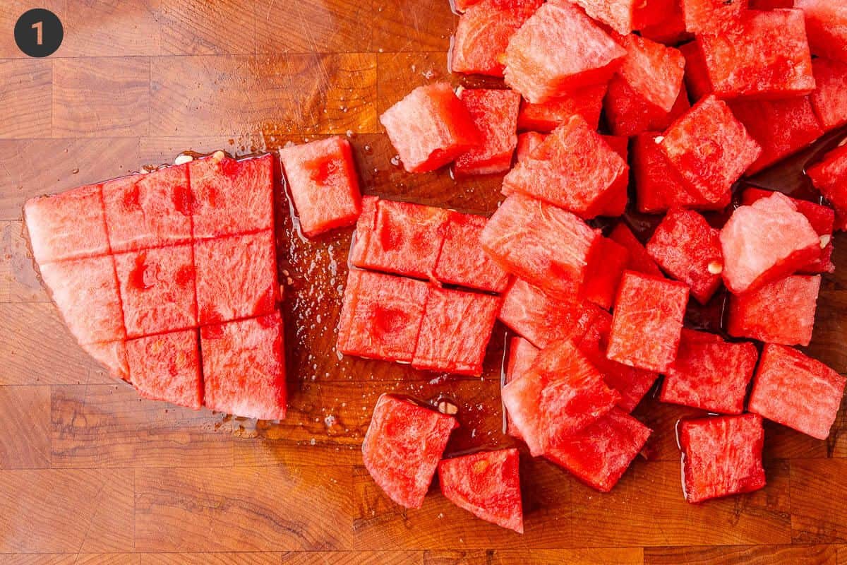 Watermelon being diced into large cubes