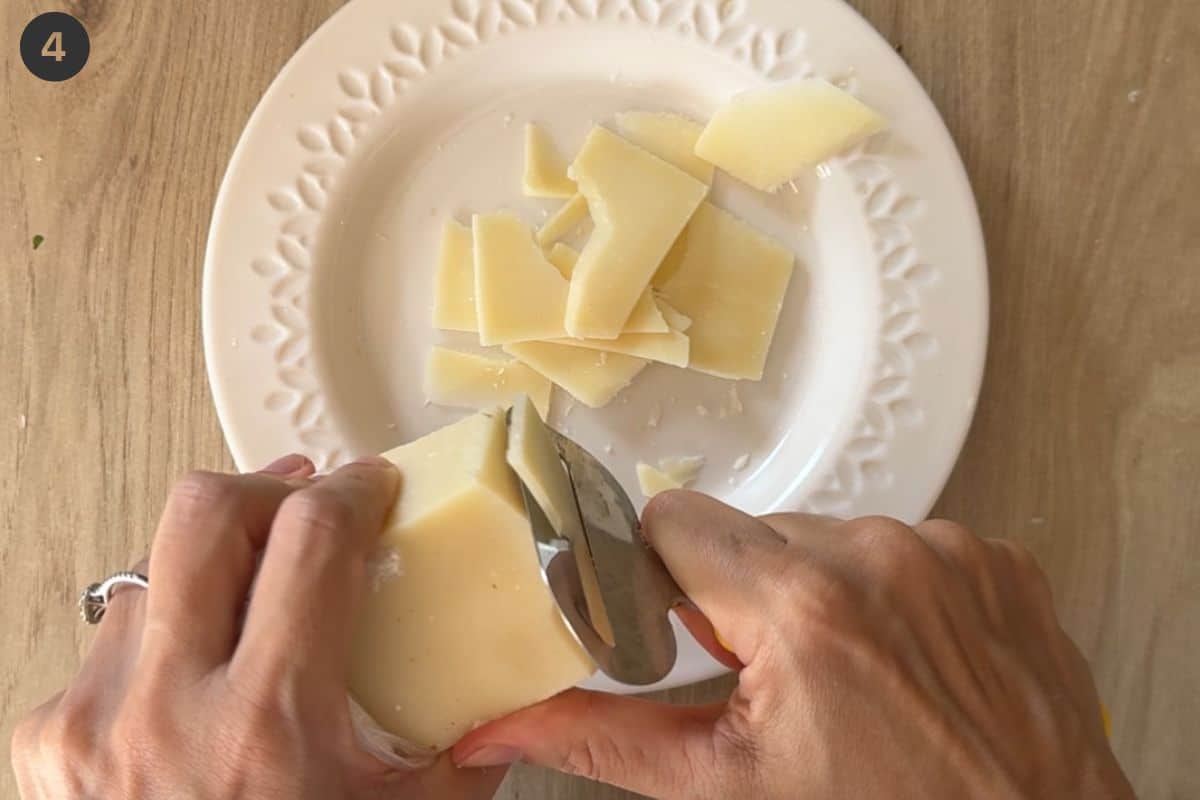 Parmesan being shaved with a cheese grater