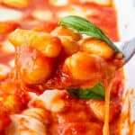 Spoon of Gnocchi alla Sorrentina coming out of the tray
