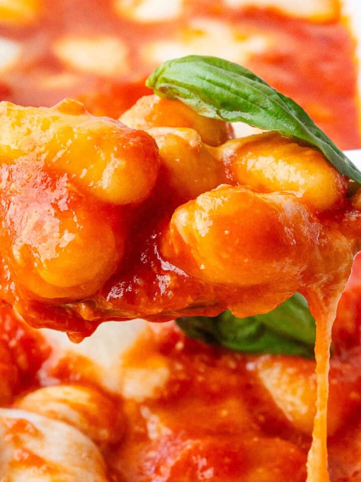Spoon of Gnocchi alla Sorrentina coming out of the tray