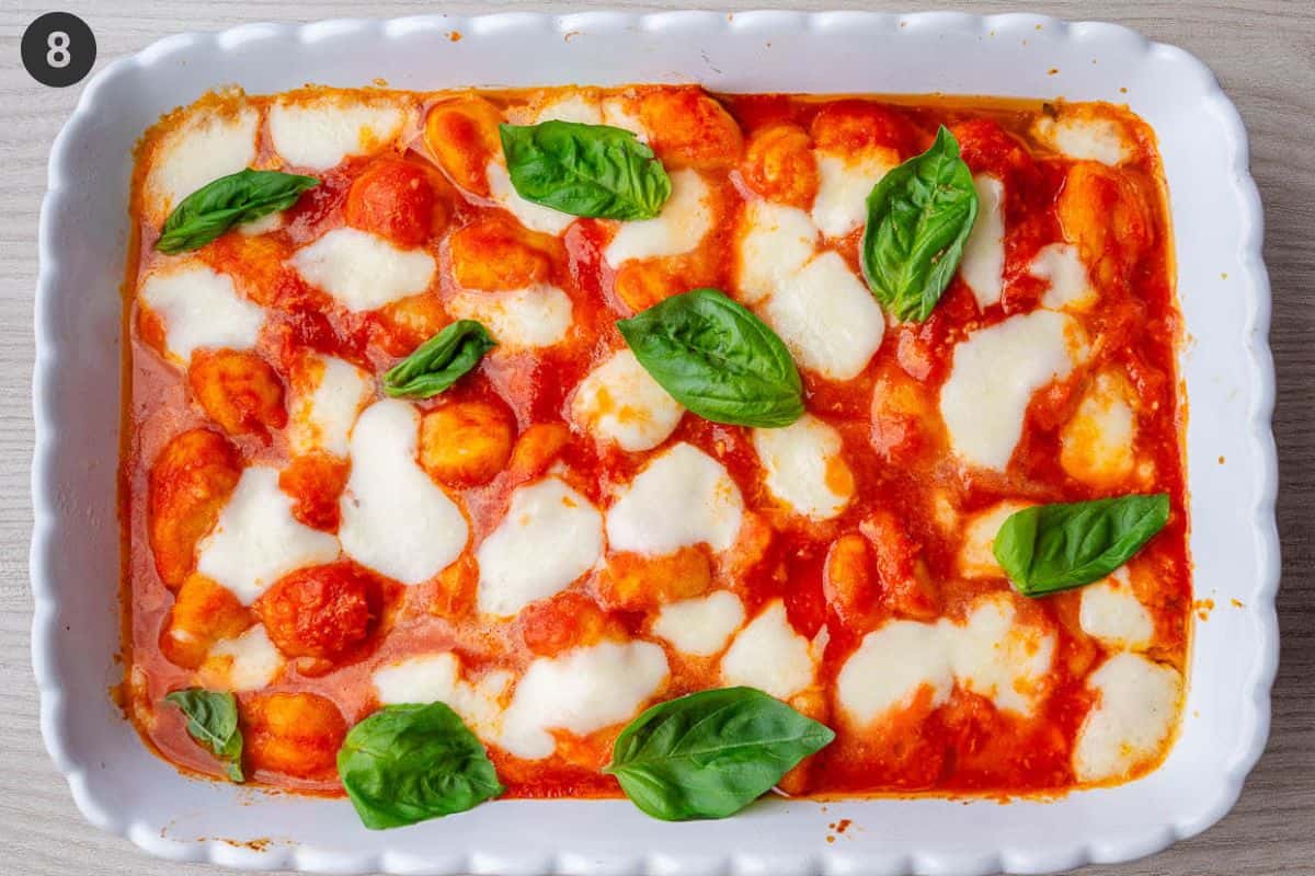 Baked Gnocchi alla Sorrentina in a tray and topped with fresh basil