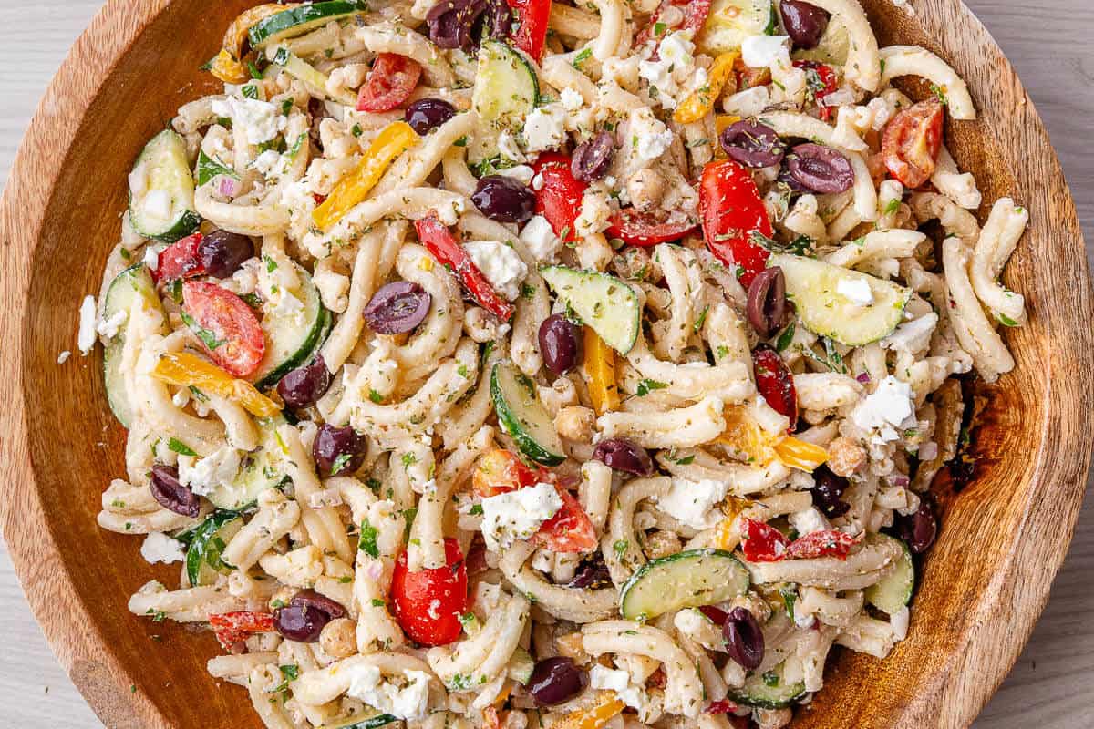Large wooden bowl of Greek Pasta Salad