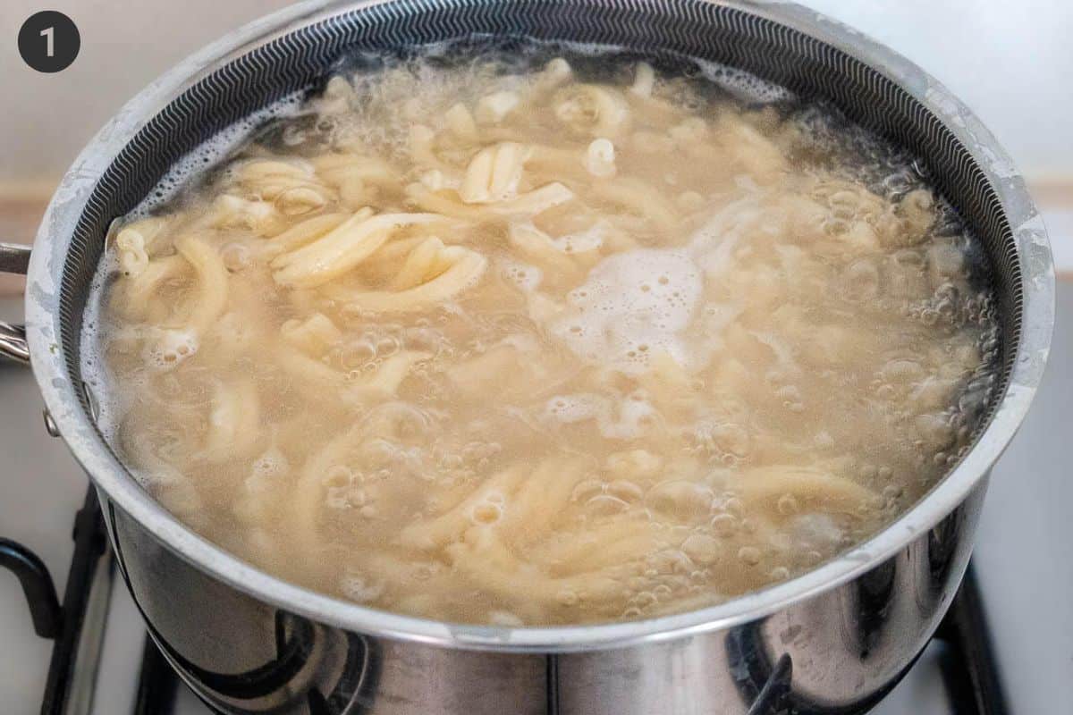 Pasta being boiled in a pot of salted water