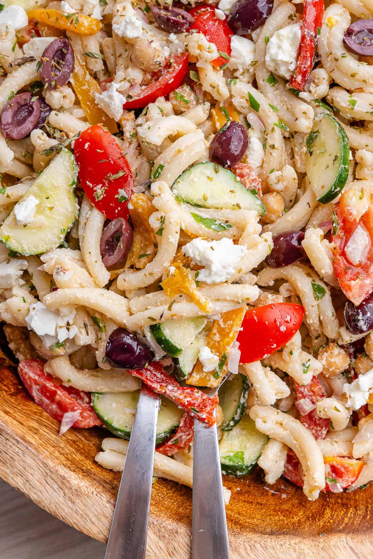 Fork and Spoon in a large bowl of pasta salad