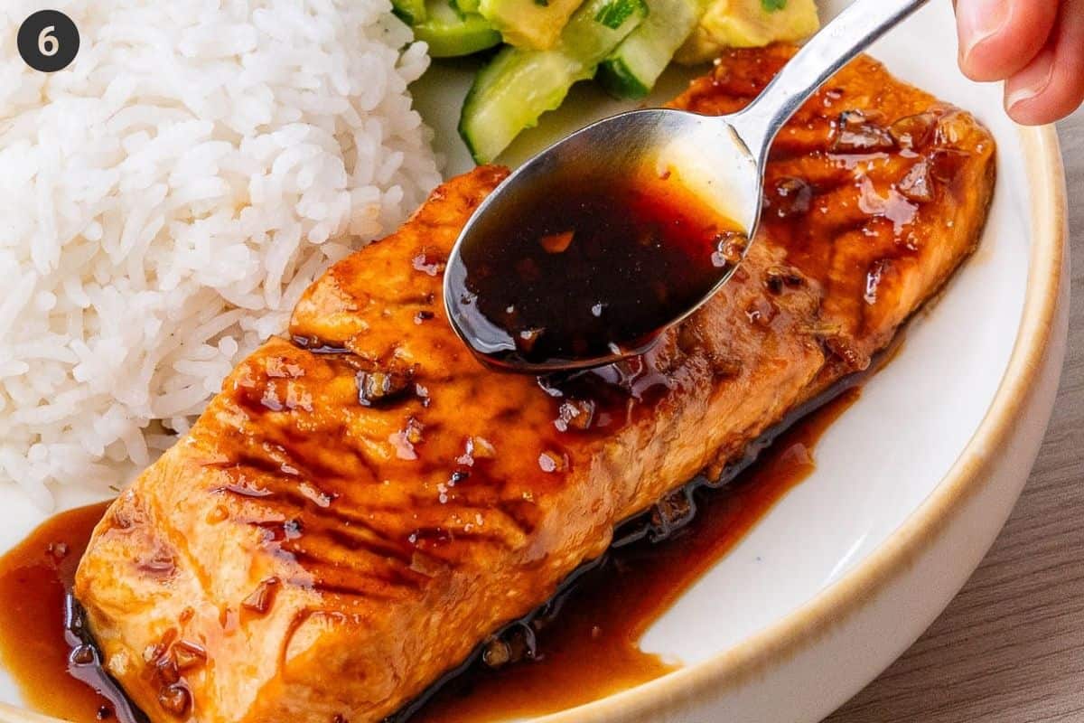 Final bowl of salmon served with a drizzle of sauce, jasmine rice and avocado cucumber salad