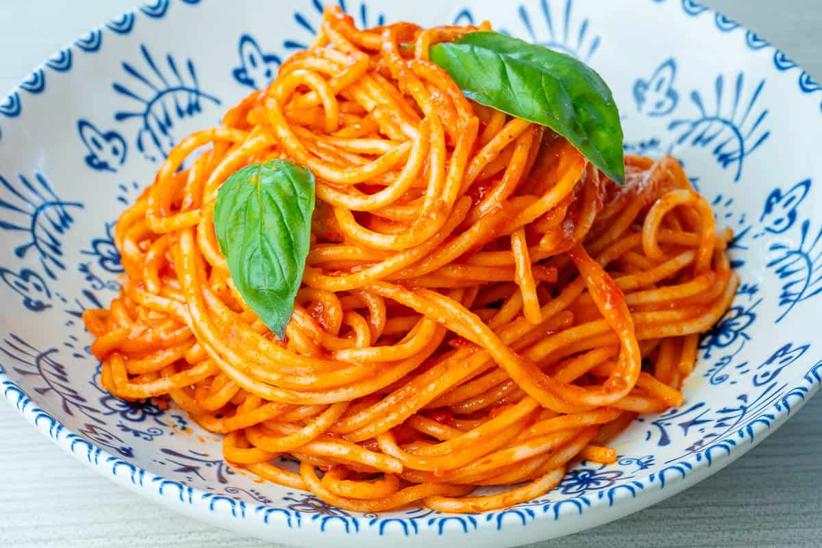 Bowl of spaghetti al pomodoro with fresh basil on top