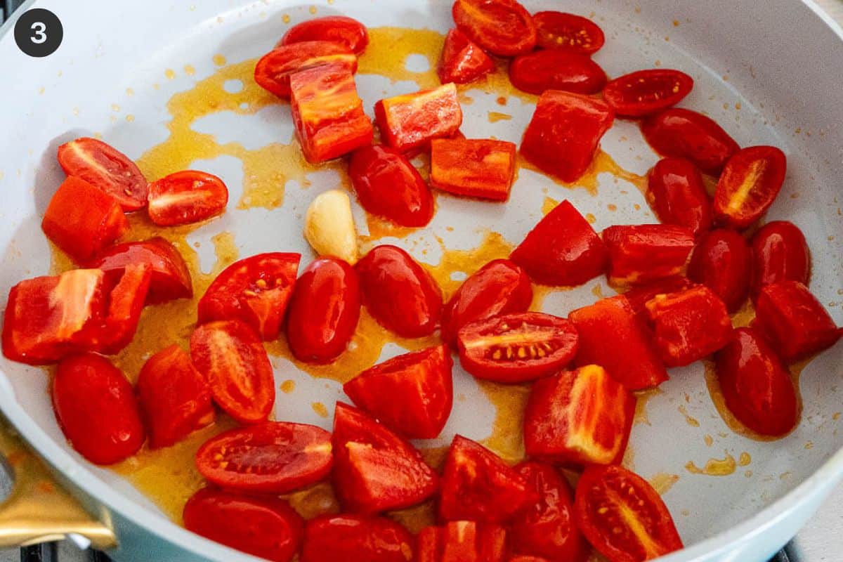Tomatoes being sauteed with garlic