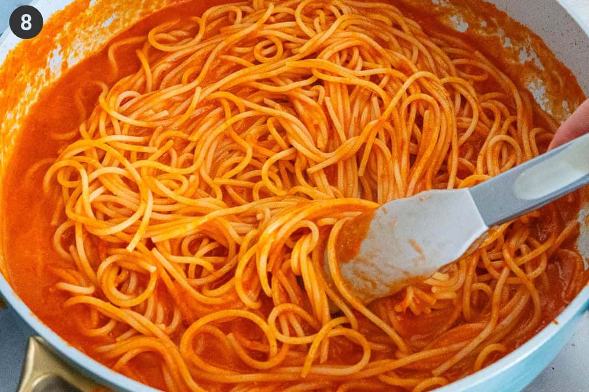 Tongs used to stir pasta and combine ingredients before serving