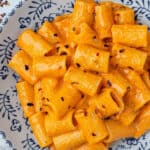 Vodka pasta topped with chili flakes in a bowl