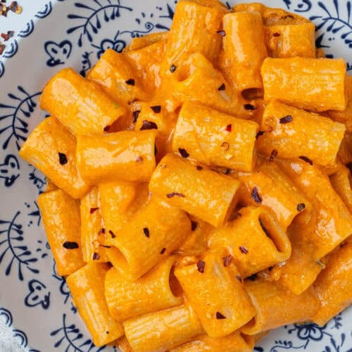 Vodka pasta topped with chili flakes in a bowl