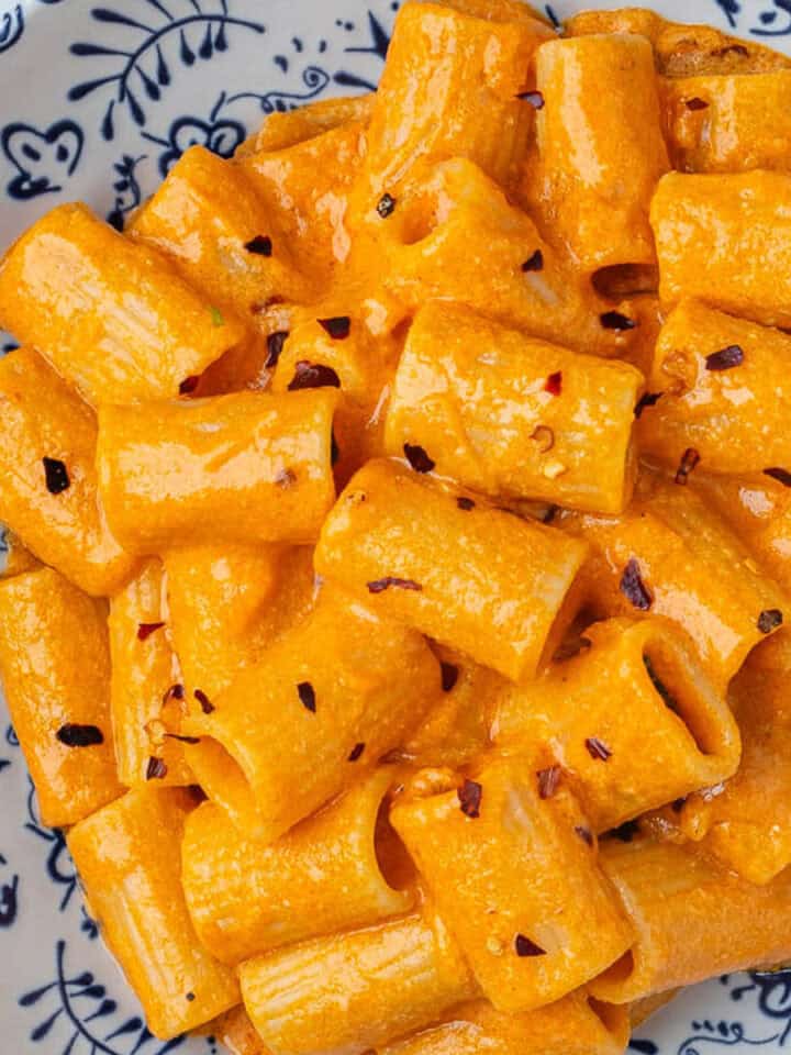 Vodka pasta topped with chili flakes in a bowl