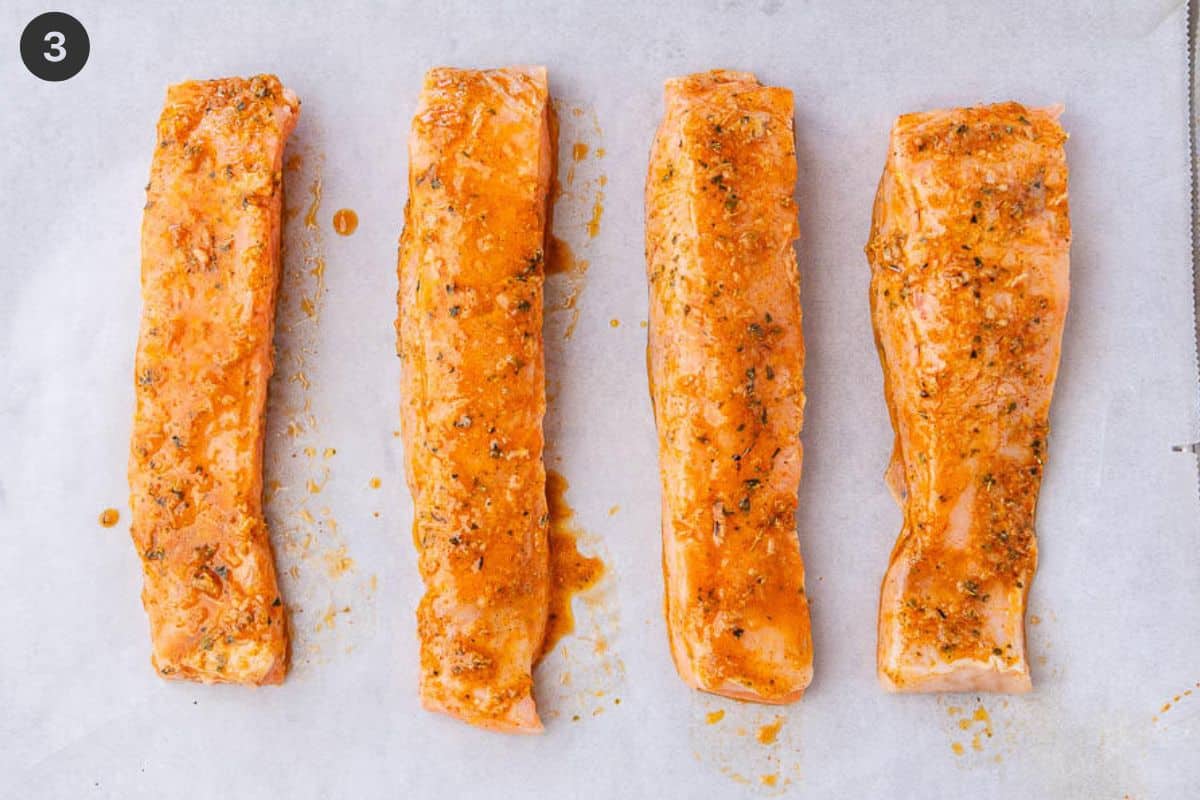 Salmon fillets covered with marinade before going into the oven