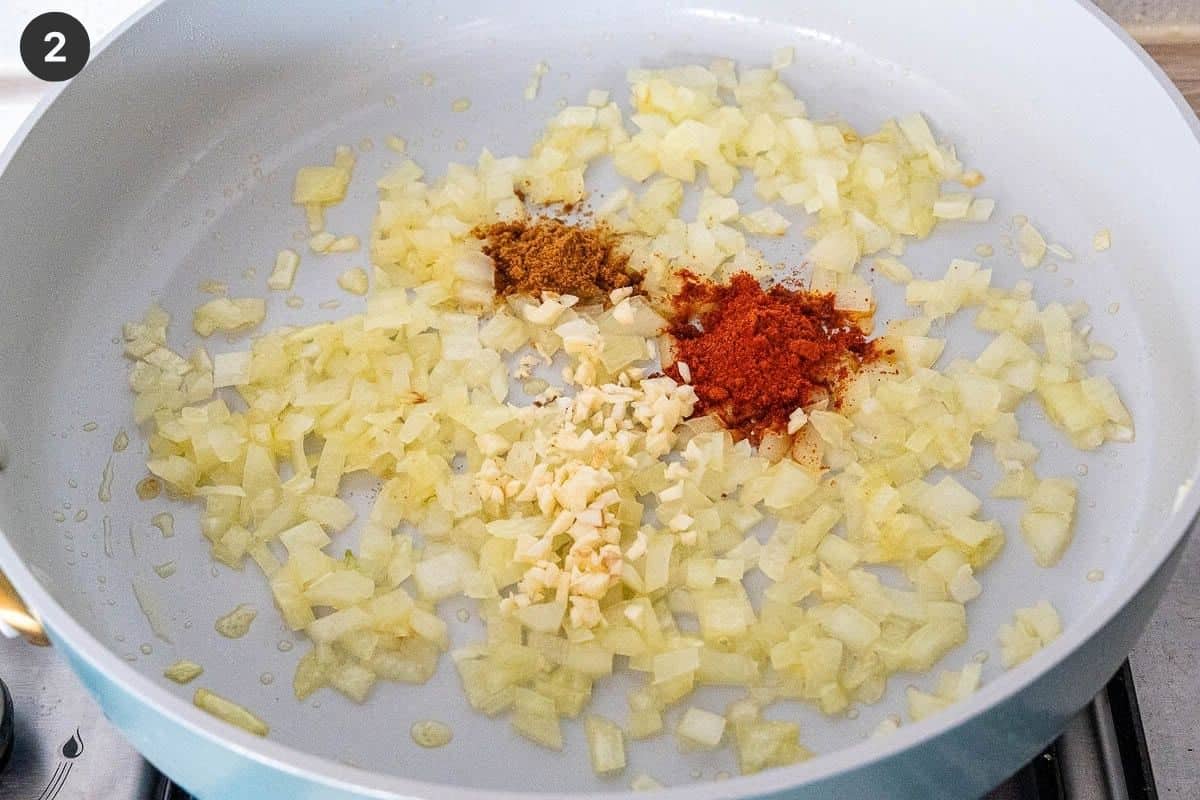Onions, garlic and spices being fried down in a pan