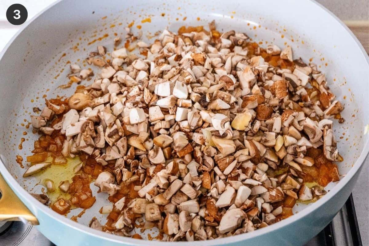 Chopped mushrooms added to the pan