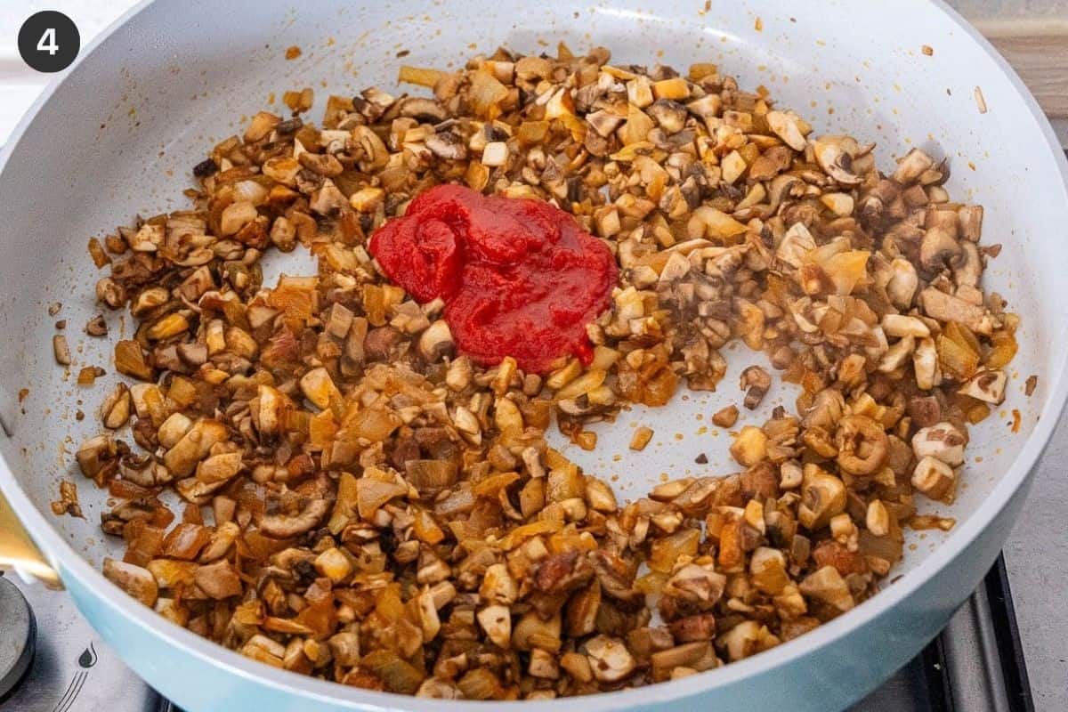 Tomato paste added to the pan