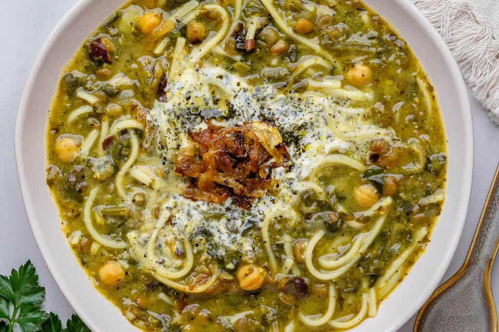 Bowl Ash Reshteh with dried mint and onions on top