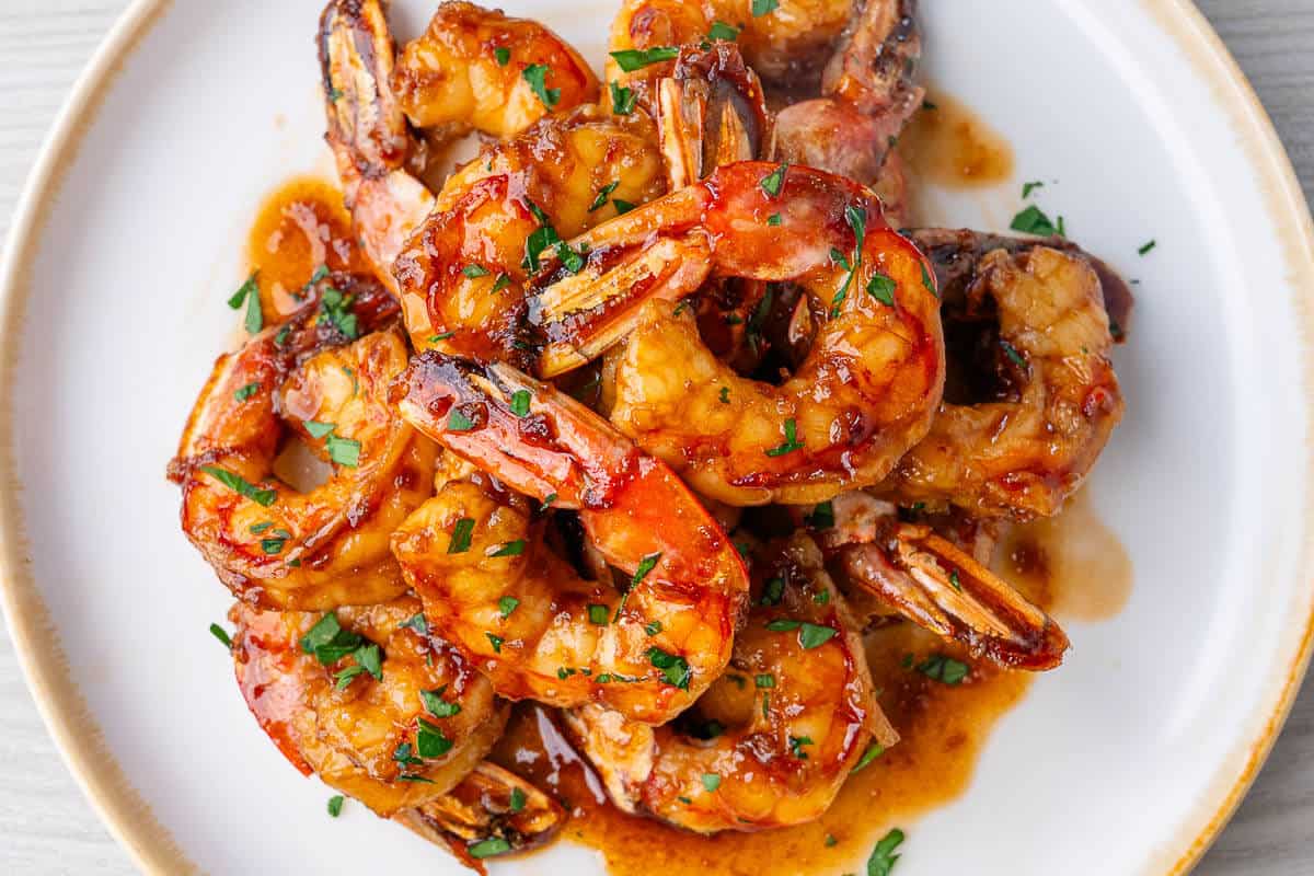 Honey garlic shrimp glazed with sauce and topped with fresh parsley