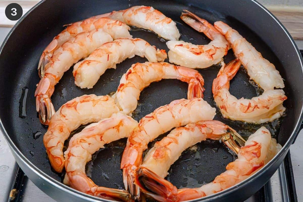 Shrimp being sautéed in a pan