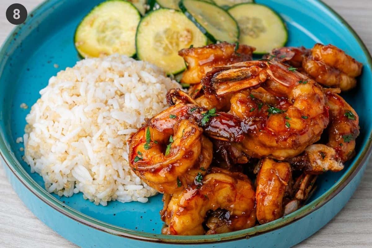 Final plate served with honey garlic shrimp, quinoa rice and cucumber salad