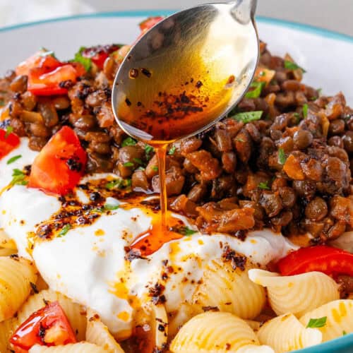 Spoon of aleppo pepper drizzled over Turkish Pasta
